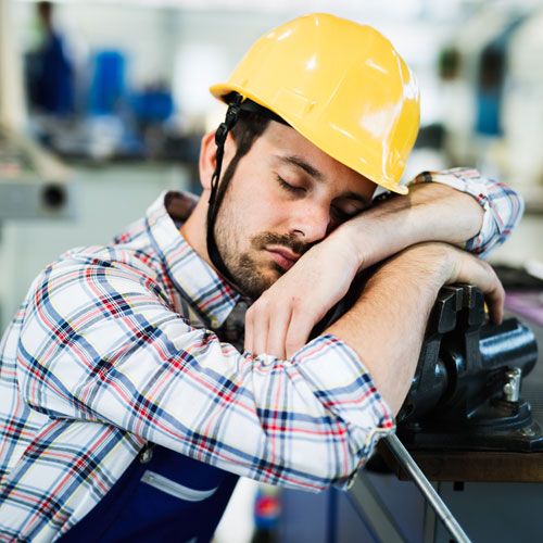 Man falling asleep at work on construction site
