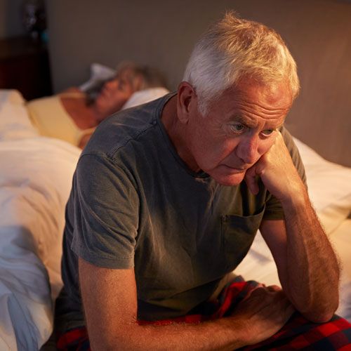 Older man suffering from restless leg syndrome
